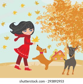 girl playing with her dogs in autumn