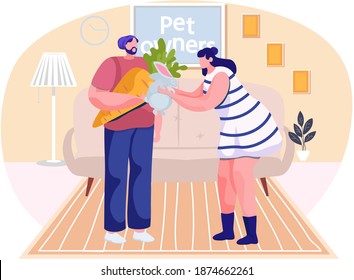 Girl plays with rabbit in the apartment. Man holding a carrot for an animal. Guy is feeding the little hare. Owners spend time together with pet. People communicate at home. Pet ownership concept