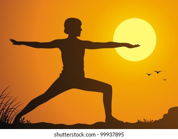 The girl practices yoga against a sunset