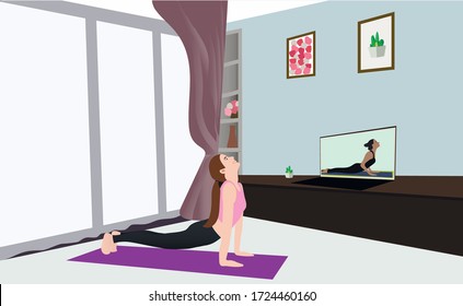 Girl practicing yoga online at home with a teacher on her laptop monitor