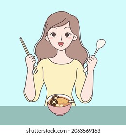 Girl preparing to drink soup, holding chopsticks and spoon in hand