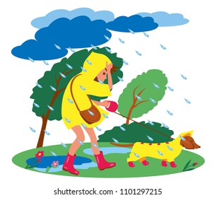 girl in raincoat walking the dog in bad weather. storm, wind and rain. 