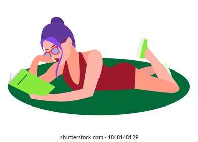 Girl reading a book. A cute girl lies on the green grass with a book in her hands. Leisure, education