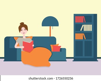 Girl reading a book under a blanket without gadgets self-isolated at home