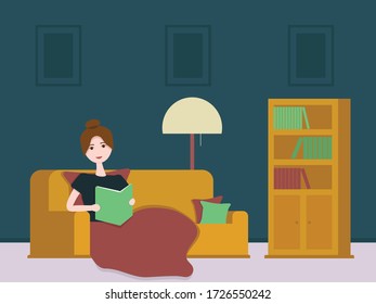 Girl reading a book under a blanket without gadgets self-isolated at home
