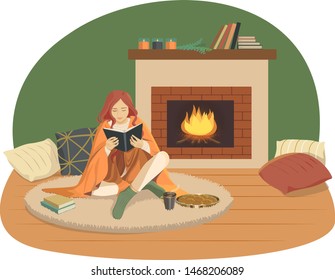 A girl reads books by the fireplace. Comfort and warmth.