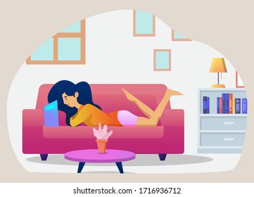 A girl is relaxing on the sofa while reading a book