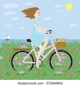 girl rides a bicycle on field flower on the background of the sea
