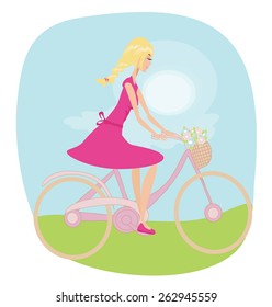 Girl is riding bike on spring field.
