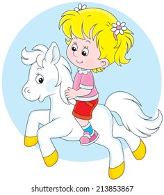 Girl riding a small white pony