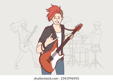 Girl rock musician plays guitar and makes gesture of goat enjoying performance at heavy music concert. Woman participating in rock band performing in nightclub with songs from new album