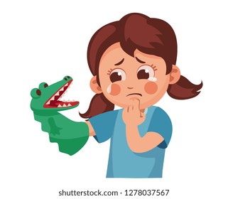 girl scared herself with a toy. child is afraid of a terrible crocodile doll.