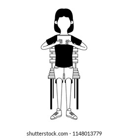 Girl seated on chair using portable videogame faceless in black and white