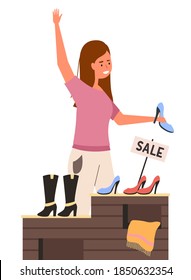 A girl with a shoe in her hands raises her hand. Shopper in a footwear shop. Female character on sale is selling or buying clothes in a store. Woman is standing next to the counter with shoes