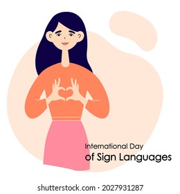 The girl shows a heart with her hands. International Day of Sign Languages. Flat vector illustration