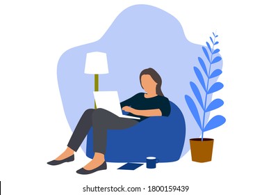 A girl sit on a flexible sofa(bean bag) and holding a laptop