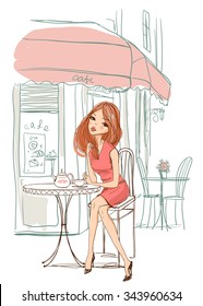 Girl sits in a cafe.