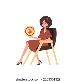 The girl sits in a chair and holds a bitcoin in her hands. Character with a modern style.