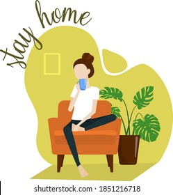 The girl sits at home in an armchair, drinks tea and relaxes. Quarantine, stay at home painting. COVID-19