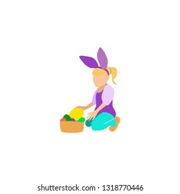 girl sits on the ground and holds an easter egg. on the head bunny ears. the girl collected eggs in a basket.
