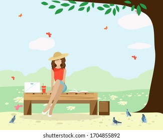 A girl sits on a Park bench with a laptop a book and a Cup and feeds pigeons