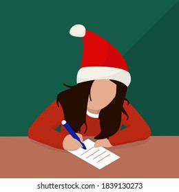  girl sits at the table in a red hat and writes a letter to Santa Claus with wishes for gifts