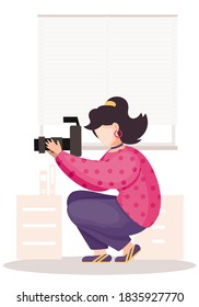 The girl sitting and adjusting the long lens. Photographic art. A woman prepares camera for a photo shoot. Photographer with camera takes picture in the photo studio on the white background