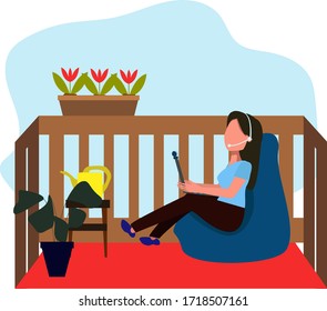 the girl is sitting in a chair with a laptop on the balcony. Freelance. The concept of working remotely from home