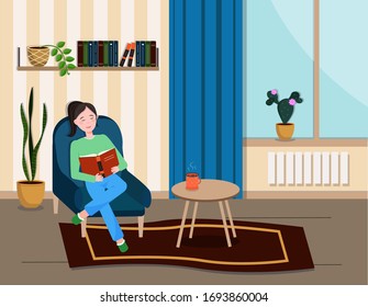 The girl is sitting in a chair and reading a book.
