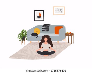 Girl sitting cross-legged in her room or apartment, practicing yoga and enjoying meditation.