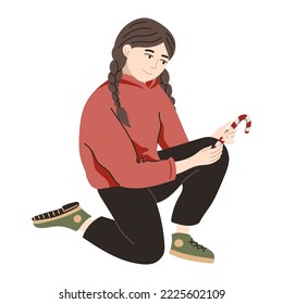 Girl sitting and holding a Christmas candy cane. Hand drawn Christmas winter illustration