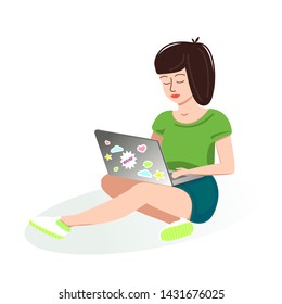 Girl sitting and holding a laptop. Student learns online, deals, shop, chat, takes and processes photos and videos. Modern lifestyle blogger or freelancer. The concept of working outside the office. 