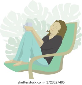 girl sitting at home in an armchair, holds a mug in her hands