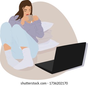 
girl sitting near a pillow, watching a movie on a laptop and drinking coffee. stay at home.