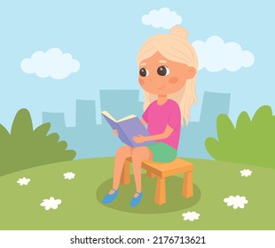 Girl sitting on a bench and reading a book. Blond schoolgirl in the park. Kid in summer garden.