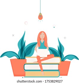 girl sitting on books with laptop