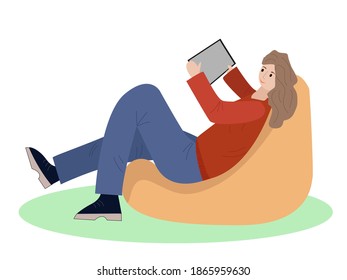 Girl sitting on chair bag and looks at the laptop.Business lady at home working chair.