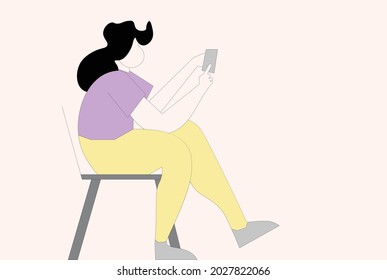 girl is sitting on a chair and holding a mobile phone 