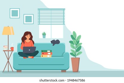 Girl sitting on the couch working on a laptop from home .