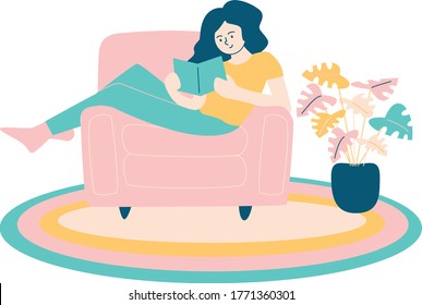 Girl sitting on a sofa and reading a book