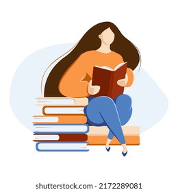 The girl is sitting and reading a book