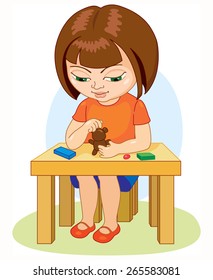 Girl sitting at the table molds from clay, education