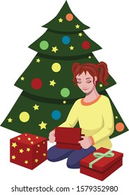 Girl sitting under Christmas tree openning her presents