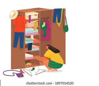 Girl squatting rummages in wooden cabinet. Clothes on hangers in the cupboard. Choose or fold clothes. Mess things. Women's fashion accessories.Wooden furniture with hanger and boxes with clothing