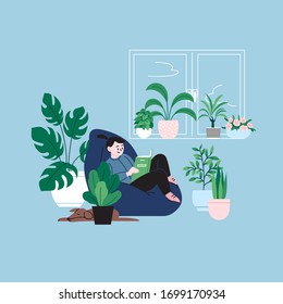 A girl staying home reading a book by the window sitting in the bean bag chair. A room full of plants.