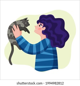 a girl in striped jacket holds cat in her arms  pet in the hands the owner  best friends