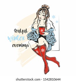 A girl in a sweater and knitted socks with a mug of hot tea. Soulful winter evenings. Inscription. Vector.