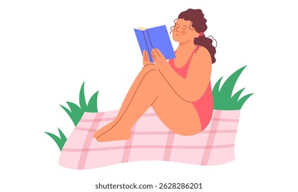 Girl in a swimming costume sits reading a book. Concept of outdoor recreation