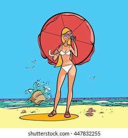 Girl in swimsuit by the sea with a sun umbrella