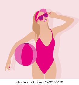 Girl in a swimsuit holding a ball for games on the beach